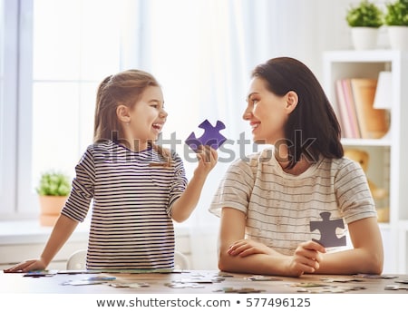 Foto stock: Cute Little Girl Solving Puzzle Together