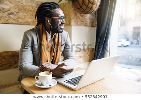 Foto stock: Elegant Businessman Working On His Laptop In A Coffee Shop Anal