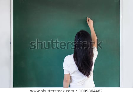 Stockfoto: Focus On A Black Woman Writing On A Blackboard In A Classroom