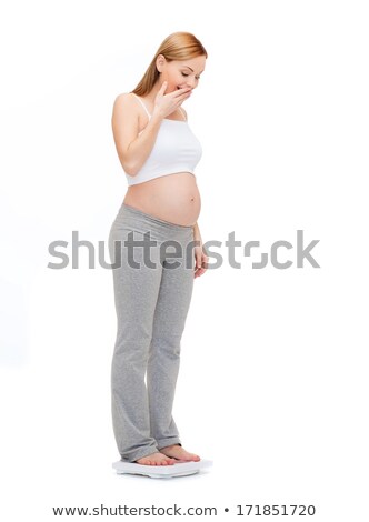 Stock photo: Amazed Pregnant Woman Weighting Herself