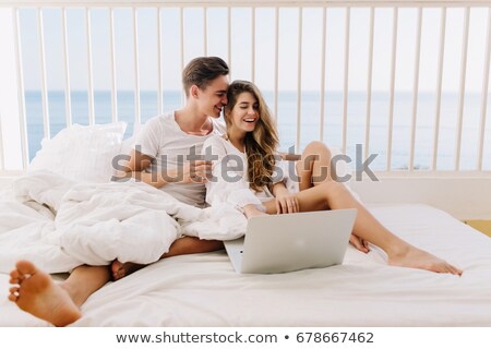 Stockfoto: Couple Relaxing Together In Bed