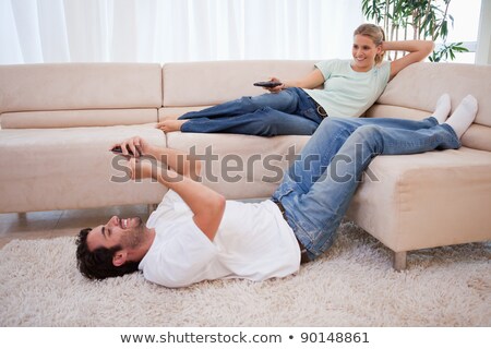 [[stock_photo]]: Young Woman Using Mobile Phone While Sitting On The Carpet