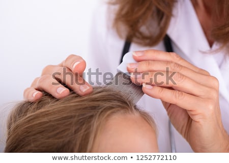 Stock photo: Doctor Examining Girl With Head Lice