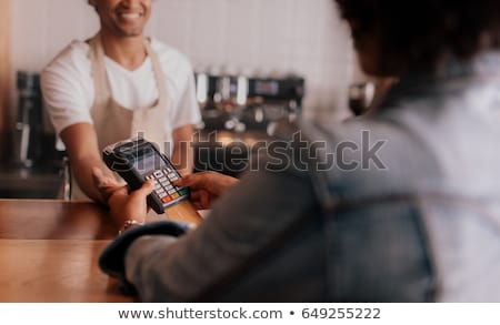 Zdjęcia stock: Customer Entering Pin Number Into Machine At Counter