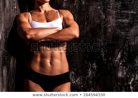 ストックフォト: Muscled Woman Against The Scratched Grunge Background