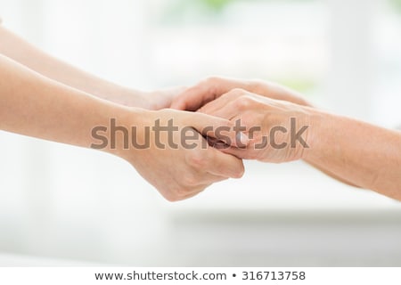 Foto stock: Close Up Of Senior And Young Woman Holding Hands
