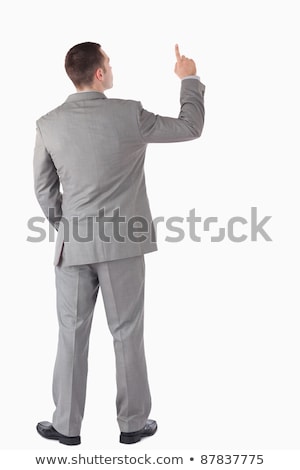 ストックフォト: Young Businessman Pointing At Something Against A White Background