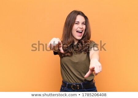 ストックフォト: Young Woman Pointing Towards Camera With Both Hands