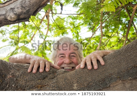Stockfoto: Smart Casual Man Leaning On A Tree In The Park
