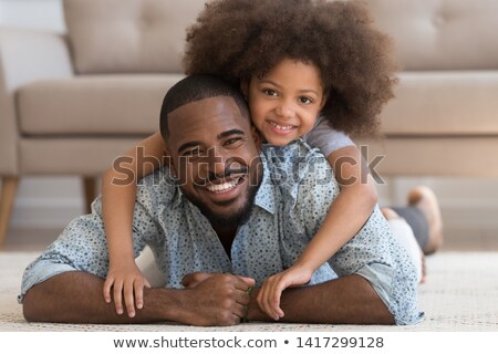 Foto stock: Headshot Of Young Girl Lying On A Carpet