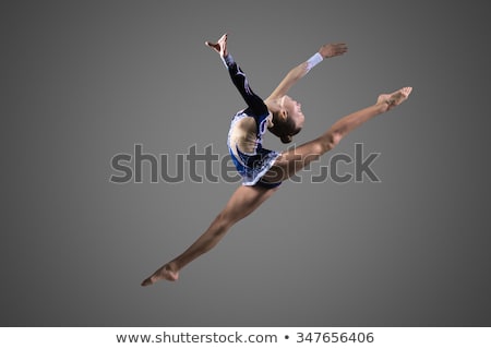 Stock fotó: Young Woman Doing Acrobatic Stunt