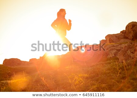 Stock photo: Young Sportsman Running On The Rocky Mountain Trail At Sunset Active Lifestyle