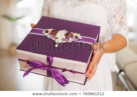 Stock photo: Woman In A White Bridal Dress Holding A Gift Box