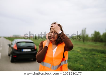 Stockfoto: Pretty Young Woman Calling The Roadside Serviceassistance