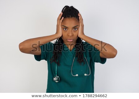 Foto d'archivio: Young Beautiful Female Doctor Covering Ears With Her Hands As Need Of Silence Medical Secret Concept