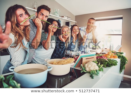 Stock foto: Cheerful Female Friends Preparing A Meal Together And Drinking R