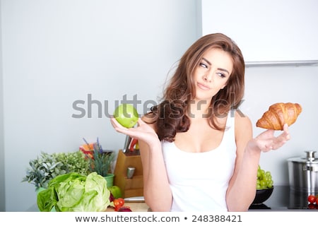 Foto d'archivio: Woman Choosing Between Green Apple Chocolate