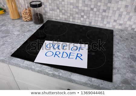Foto stock: Out Of Order Text Stuck On Induction Stove