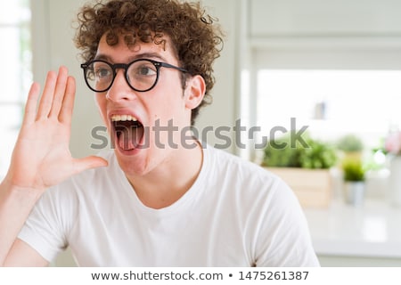 Сток-фото: Portrait Of A Young Man Shouting Loud With Hands On The Mouth