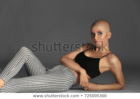 Stok fotoğraf: Lying Young Woman Wearing Extravagant Clothes