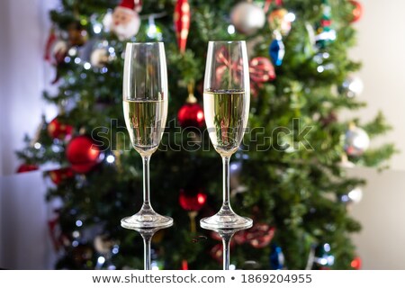 Foto stock: Two Glasses Of Sparkling Champagne Infront Of Black Background