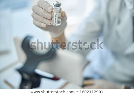 Foto stock: Science Student Holding Up Vial