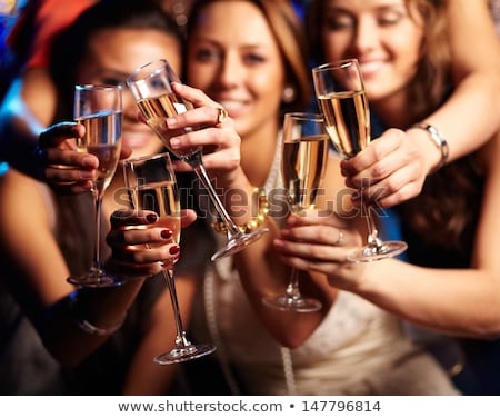 ストックフォト: Group Of Partying Girls With Flutes With Sparkling Wine And Beng