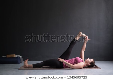 Fit Woman Practicing Reclining Big Toe Yoga Pose Foto stock © Koldunov