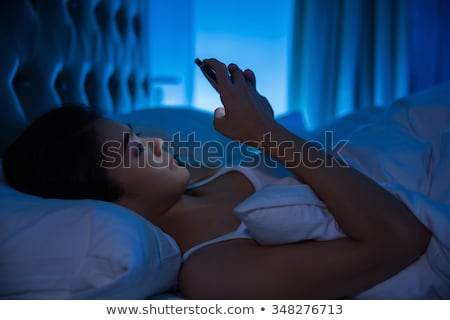 Сток-фото: Woman In Bed With Phone