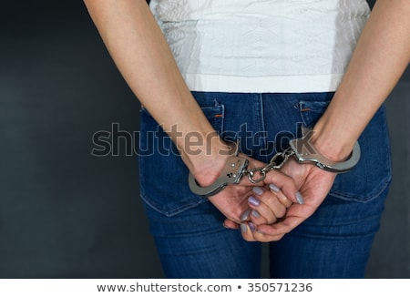 Foto d'archivio: Female Hands In Handcuffs