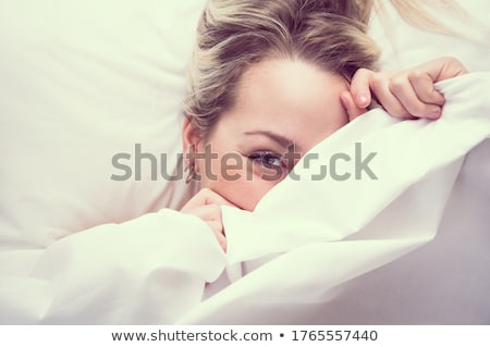 Foto d'archivio: Shy Cute Lovely Young Woman Hiding Her Face Behind Sheet