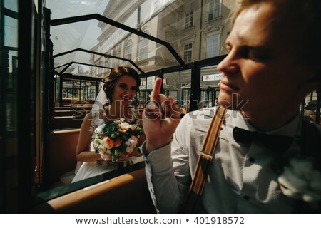 Stockfoto: Bride And Groom Posing In A Tour Car