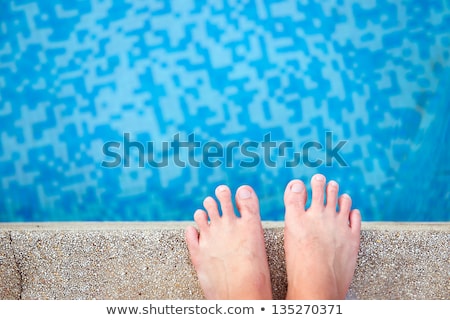 Stockfoto: Male Feet In Outdoor Swimming Pool