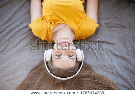 Foto stock: Woman Listening To Music On Mp3 Player