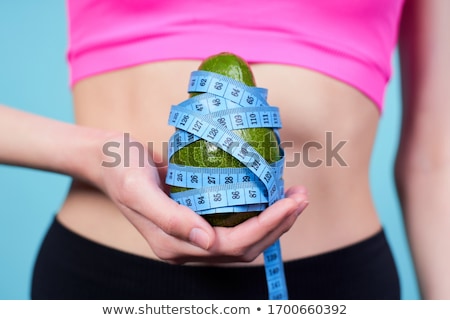 Stock photo: Cropped Shot Of Sporty Girl Holding Avocado
