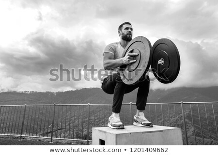 Stock photo: Sportsman Is Squatting On Top Of Hill