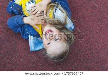 [[stock_photo]]: Girl With Natural Blond Hair Liying On The Floor