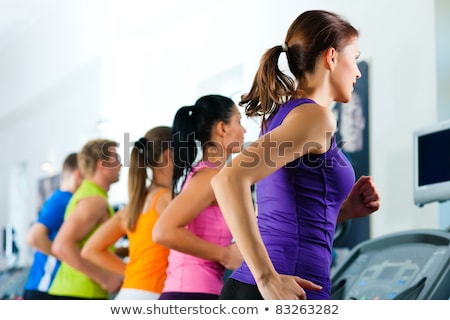 Young Woman Exercise On The Treadmill At The Gym Foto d'archivio © Kzenon