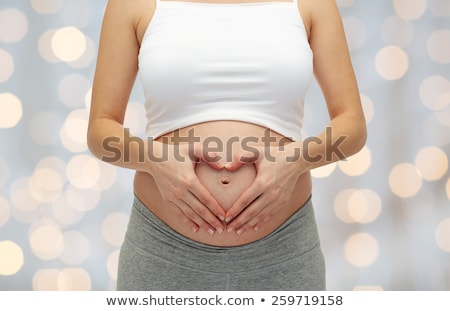 Foto stock: Close Up Of A Cute Pregnant Belly Heart