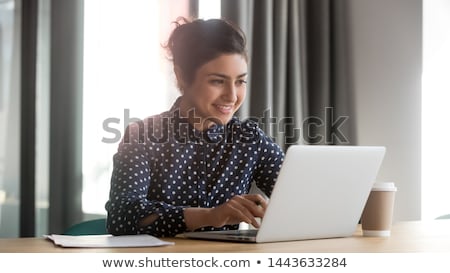 Foto stock: Beautiful Young Girl Is Sitting At The Table In The Office And Is Holding Negotiations