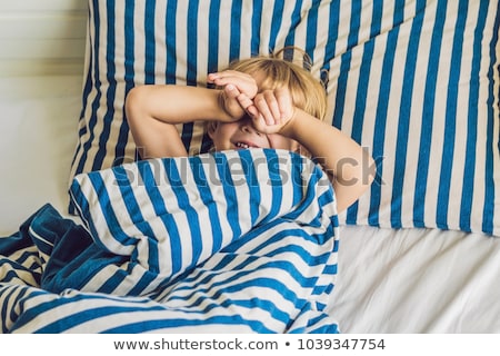 Stock photo: The Cute Boy Woke Up In His Bed Children Sleep Concept