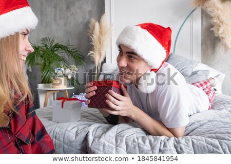 Stock photo: Smiling Woman In Pajama Holding Gift Box And Looking At The Camera Valentines Day Concept