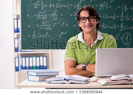 Foto stock: Handsome Student In Front Of Chalkboard With Formulas