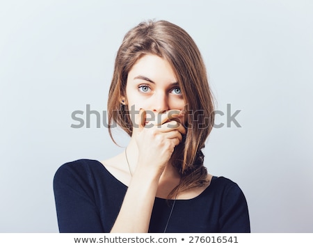 Foto stock: Woman Holding Her Hand Over Her Mouth In Silence