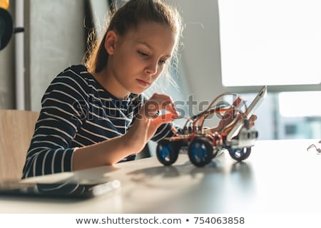 Foto stock: Little Girl Repairing Computer Parts