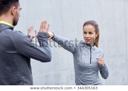 Stockfoto: Happy Woman With Coach Working On Strike Outdoors