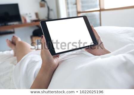 Foto d'archivio: Girl Lay Bed At Home With Tablet Technology