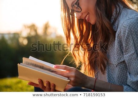 Zdjęcia stock: Beautiful Young Woman In Glasses Reading A Book