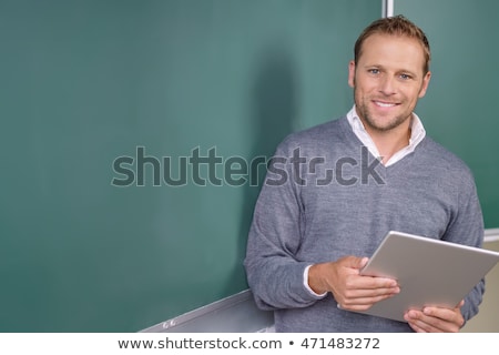 Stockfoto: Young Male Teacher In Front Of Chalkboard