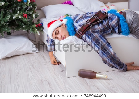 Foto d'archivio: Man Suffering Hangover After Christmas Party
